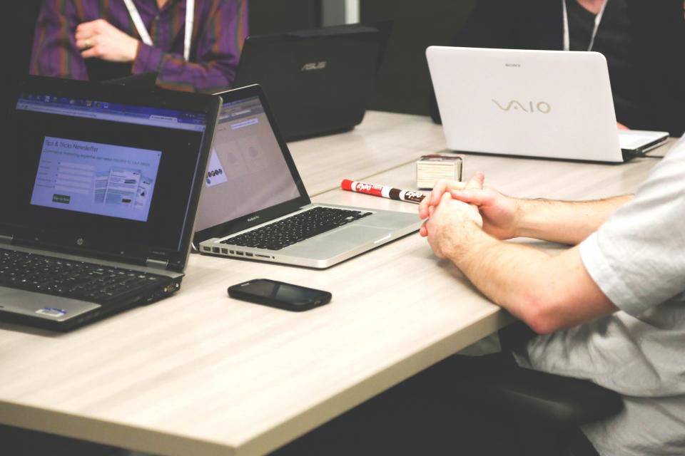 Colleagues working together on laptops in a bright office
