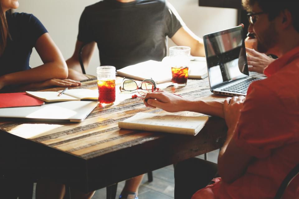 Team members collaborating around a table during a meeting